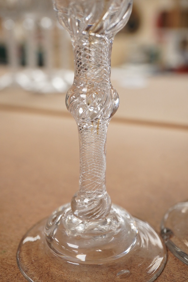 Four Georgian wine glasses, three with engraved bowls, three with faceted stems, and one with an air twist knopped stem and stepped foot, tallest 16cm